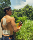 Outdoor athlete with Kaiser Herbal Soothe plaster along spine for muscle relief