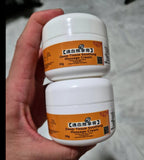 Hand holding Kaiser Deep Tissue Soothing Massage Cream 30g jars