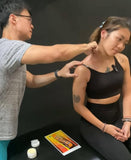 Sports massage therapist applying Kaiser Deep Tissue Cream to athlete neck and trapezius